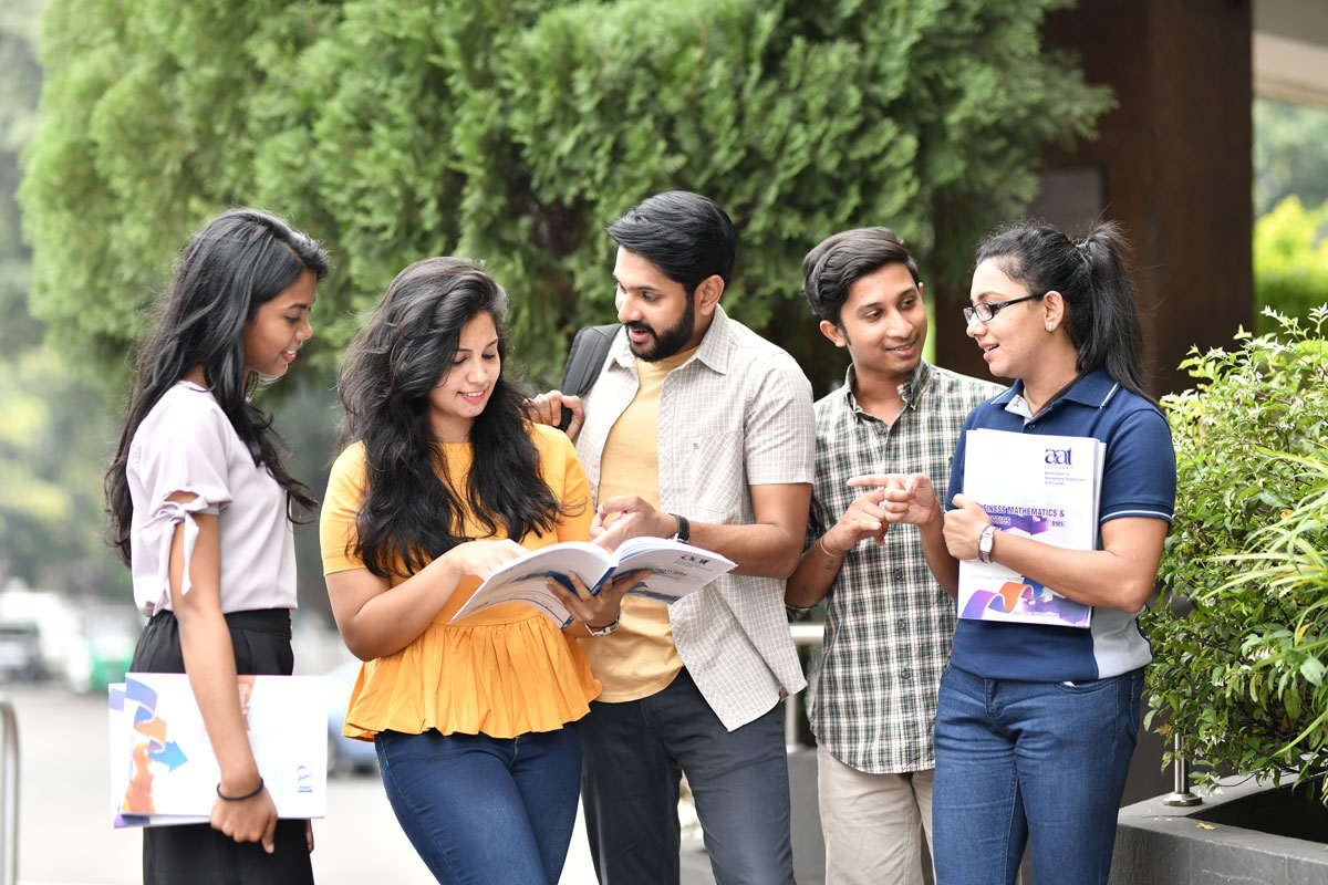 College students standing outdoors and reading together, representing teamwork and healthy campus life